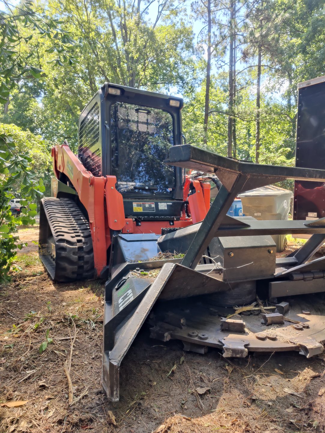 Track loader with mulcher attachment — ClearThisLand field equipment